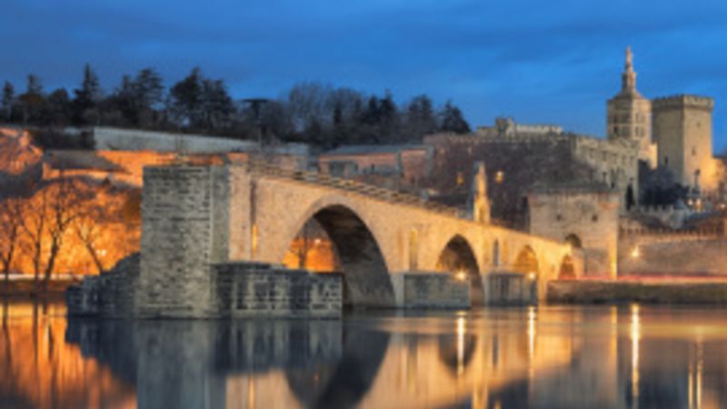 View on Pont d'Avignon 12th century bridge and city skyline refl
